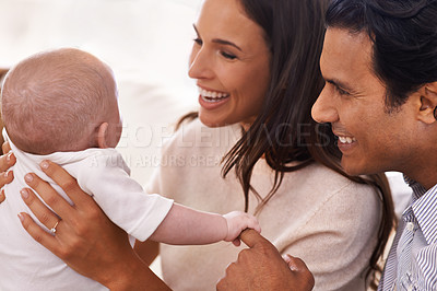 Buy stock photo Cropped shot of an affectionate couple and their newborn baby