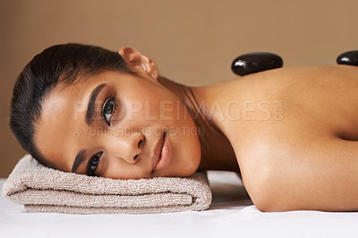 Buy stock photo Portrait of woman, rock or back massage in spa to relax for zen, resting or wellness physical therapy. Face of girl client in salon to exfoliate for skincare healing treatment or hot stone therapy 