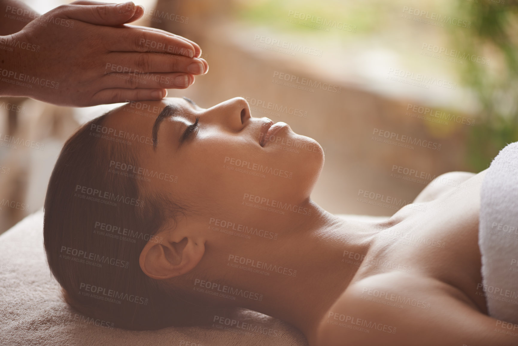 Buy stock photo Shot of a beautiful young woman getting a head massage at a spa