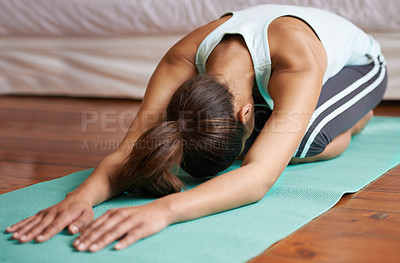 Buy stock photo An attractive young woman working out at home