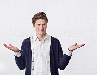 Buy stock photo Confused, thinking and man with doubt on a white background for choice, option and decision. Facial expression, reaction and isolated person with unsure, question and wonder shrug gesture in studio