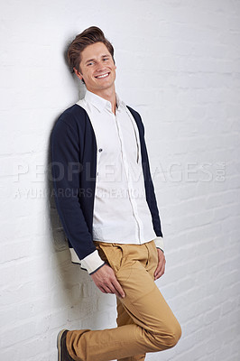Buy stock photo Smile, fashion and portrait of man by wall with casual, cool and trendy outfit for confidence. Happy, handsome and young male person with attractive style standing by white brick background.
