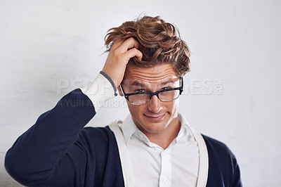 Buy stock photo A young man with messy hair looking perplexed