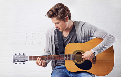 Buy stock photo Music, mockup and man with guitar for artistic, sound or creative expression on wall background. Musical, instrument and male person with acoustic, melody or feel good hobby, fun or practice routine