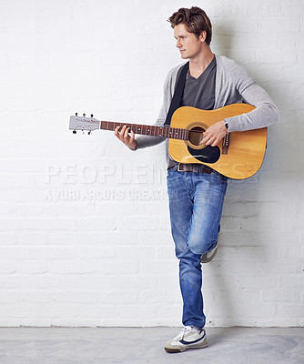 Buy stock photo Man, guitar and musician with creativity and music, acoustic for entertainment and performance against wall background. Busker, artist and musical instrument for art, track or song with talent