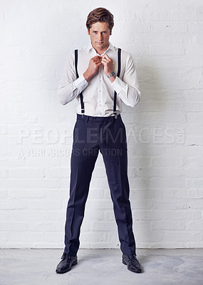 Buy stock photo Man, portrait and fashion with getting ready, confidence and suit with trendy and stylish clothes. Hipster, male person and wall with event, classic and fancy suspenders with dressing formal