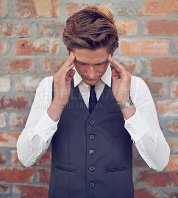Buy stock photo Shot of a well dressed young man looking stressed out