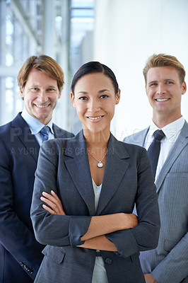 Buy stock photo Portrait of three smiling executives standing in an office lobby