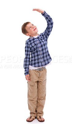 Buy stock photo Children, growth and mockup with a boy measuring his height in studio isolated on a white background. Kids, hand and wall with a male child growing up to be tall on blank space for development