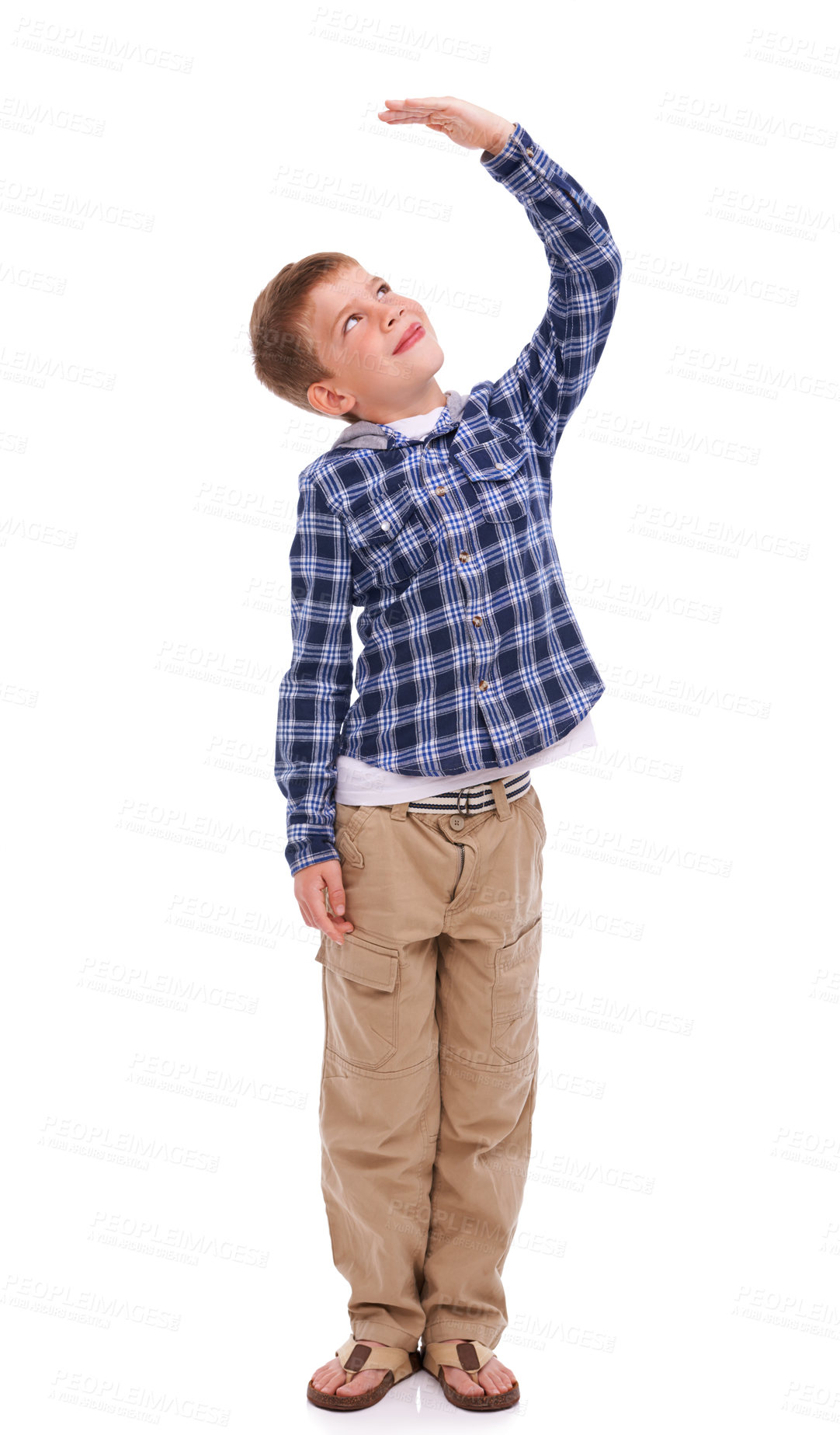 Buy stock photo Children, growth and mockup with a boy measuring his height in studio isolated on a white background. Kids, hand and wall with a male child growing up to be tall on blank space for development