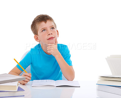 Buy stock photo Young boy, writing and thinking with books at desk for school, education study and student knowledge. Paper, working and child focus for learning, creative drawing or creativity idea vision in studio