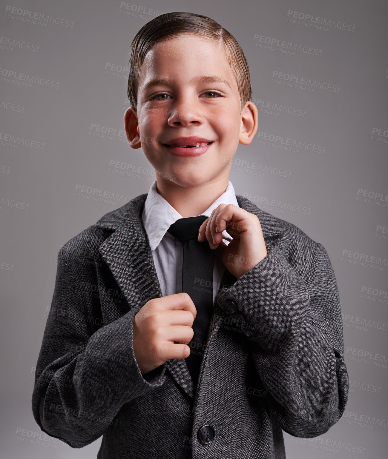 Buy stock photo Studio shot of a cute young boy wearing a retro suit against a grey background