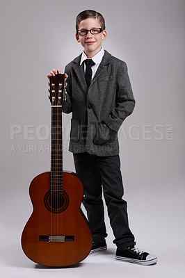 Buy stock photo Studio shot of a young musician dressed in a suit