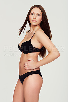 Buy stock photo A voluptuous model posing against a white background