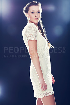 Buy stock photo Cropped view of a beautiful young woman in a lacy cocktail dress against a blue background