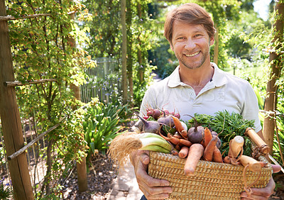 Buy stock photo A mature man holding a basket of organic vegetables