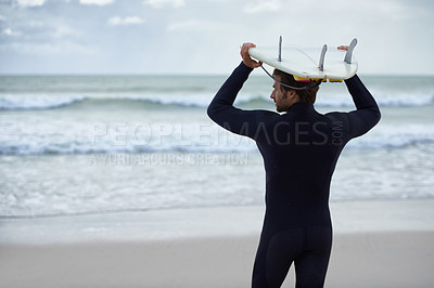 Buy stock photo A surfer with his surfboard at the beach