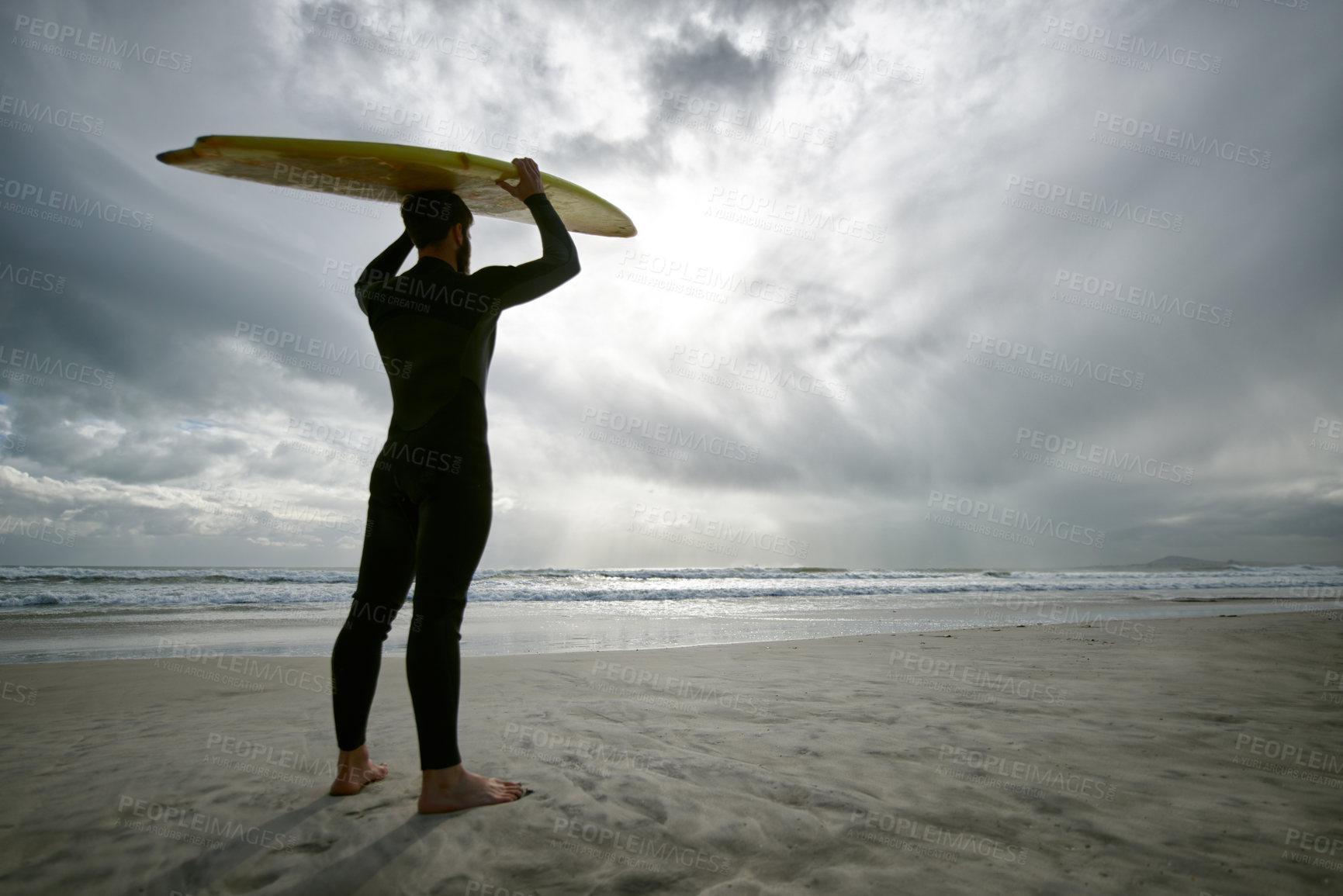 Buy stock photo Man, surfer and wetsuit at beach for waves, sport or exercise on sandy shore in outdoor fitness. Rear view of male person or athlete with surfboard for surfing on ocean coast, sea or water in nature