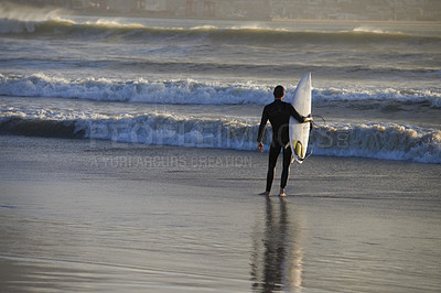 Buy stock photo A young surfer with his board at the beach