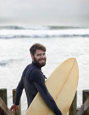 Buy stock photo Happy man, portrait and surfer on beach for fitness, sport or waves on shore in outdoor exercise. Young male person with smile and surfboard for surfing challenge or hobby on ocean coast in nature