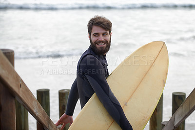 Buy stock photo Happy man, surfer and beach by waves for fitness, exercise or extreme sports on outdoor shore. Young male person with smile and surfboard for surfing challenge or hobby at ocean coast, sea or nature