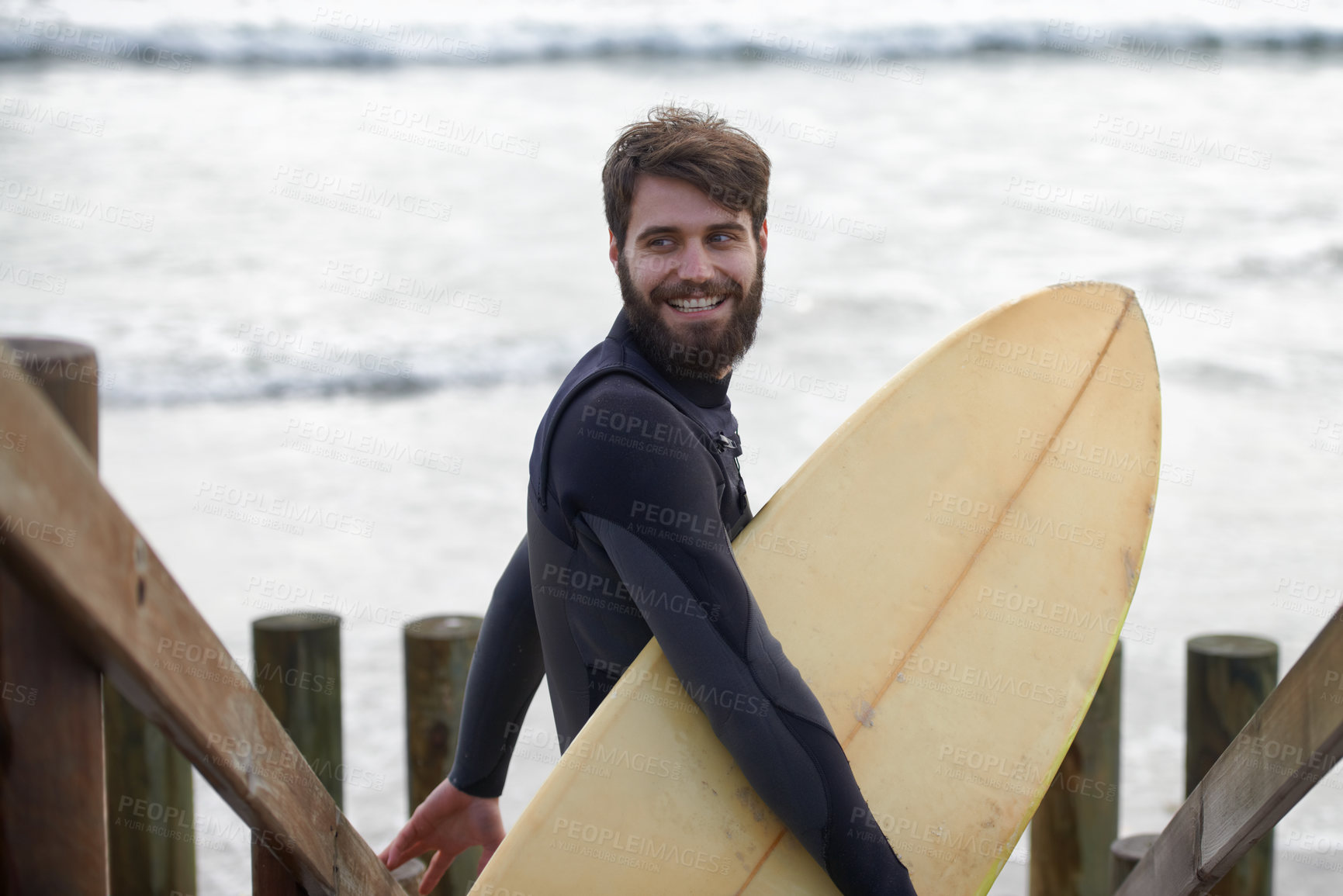 Buy stock photo Happy man, surfer and beach by waves for fitness, exercise or extreme sports on outdoor shore. Young male person with smile and surfboard for surfing challenge or hobby at ocean coast, sea or nature