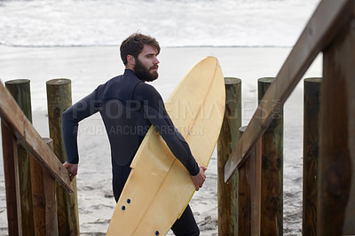 Buy stock photo Man, surfer and beach by waves in fitness, exercise or extreme sports on outdoor shore. Rear view of male person or athlete with surfboard for surfing challenge or hobby at ocean coast, sea or nature