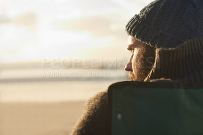 Buy stock photo Face, thinking and man at beach at sunset to relax on holiday or vacation for travel in summer. Nature, sunshine and view with young person on coast by sea or ocean for peace and quiet from back