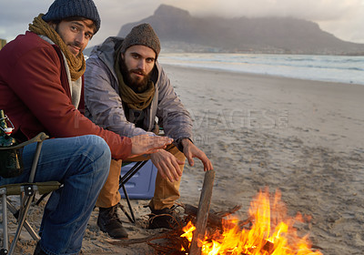 Buy stock photo Campfire, friends and portrait with men by the beach at sunset with vacation and camping. Ocean, outdoor and together with travel and people in a trip and journey with fire and conversation by sea