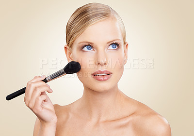 Buy stock photo Beauty, brush and face of woman in studio with confidence, natural makeup or facial glow. Glamour, cosmetics and girl thinking on beige background with healthy skin shine, inspiration and wellness.
