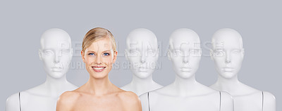 Buy stock photo Woman, mannequins and smile for identity, beauty and individuality on studio background. Person, skincare and dummy with face for creativity and cosmetics or unique ideas for satisfaction and skin