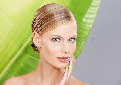 Buy stock photo Woman, palm leaf and skincare in portrait for beauty, glow and routine in studio. Female person, natural and face with confidence for wellness, detox and hydration benefits on gray background