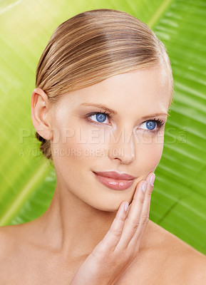 Buy stock photo Woman, smile and natural skincare with leaf for beauty, glow and hydration benefits. Female person, makeup and hand on face with confidence for wellness, detox and daily routine on green background