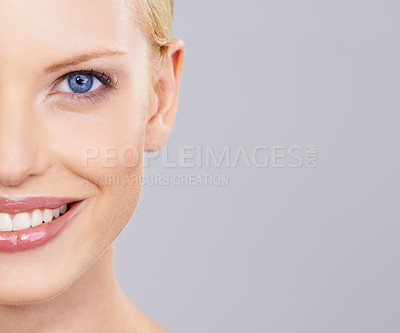 Buy stock photo Beauty, cosmetics and half portrait of woman with smile, natural makeup or facial glow in studio mockup. Happiness, skincare and face of girl on grey background space for health shine and wellness.