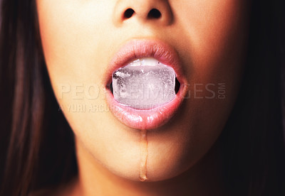 Buy stock photo Shot of a woman holding an ice block in her mouth