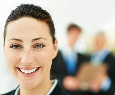 Buy stock photo Portrait of a businesswoman with colleagues standing in the background