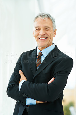 Buy stock photo Shot of a mature business standing in an office building hallway