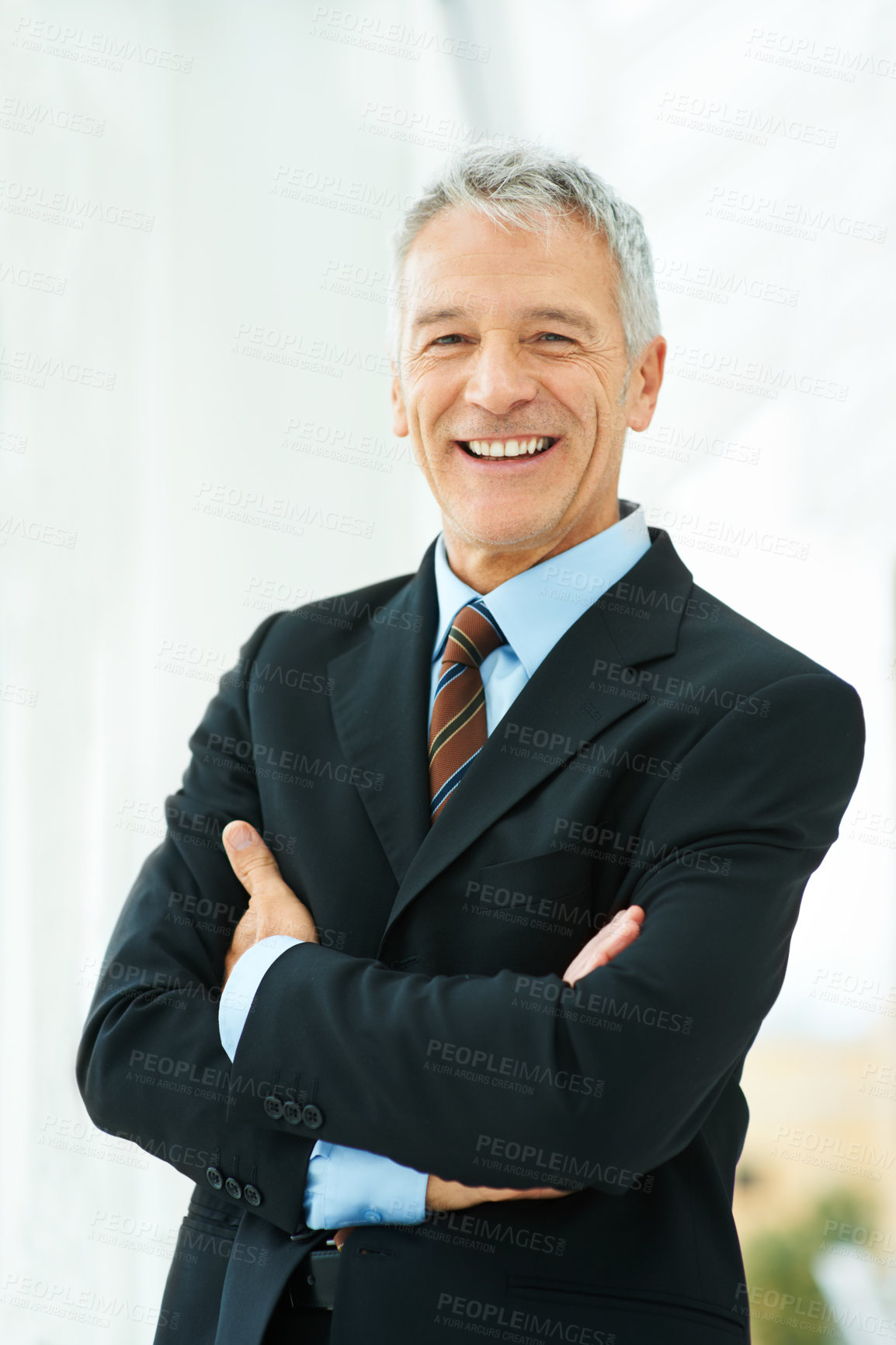 Buy stock photo Shot of a mature business standing in an office building hallway