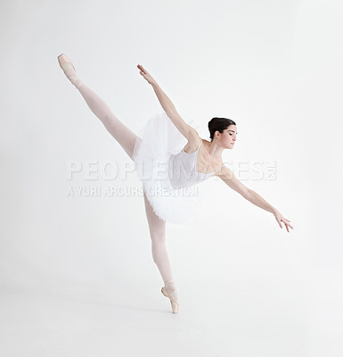 Buy stock photo Ballet dancer, pointe shoes and balance or white background expression performance training, elegance or competition. Female person, legs stretch or posture talent as  athlete, strong sport or pose