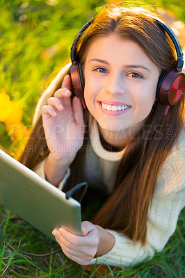 Buy stock photo Woman, headphones and tablet in portrait on grass, streaming radio and podcast in outdoors. Happy female person, nature and internet for classical playlist on weekend, calm and peaceful song on lawn