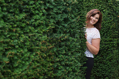 Buy stock photo Happy, portrait and a woman in a nature maze, enjoying environment and peeking from a hedge. Smile, beautiful and a young person by a bush or plants for playing, walking or outdoor weekend fun