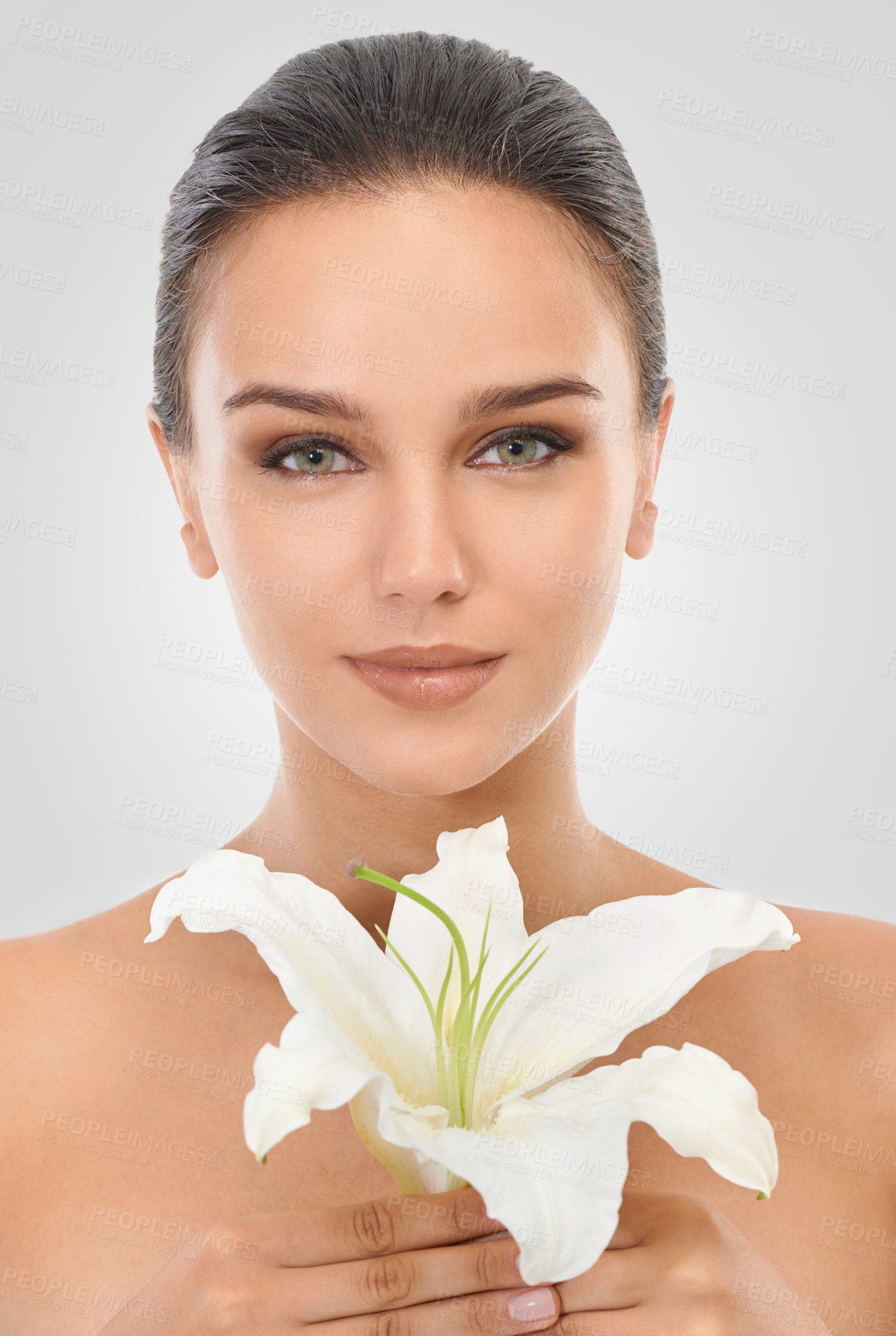 Buy stock photo Makeup, floral and portrait of woman in studio with glamour, glow and cosmetic face routine. Beauty, confident and young female person with flower plant for facial cosmetology by gray background.