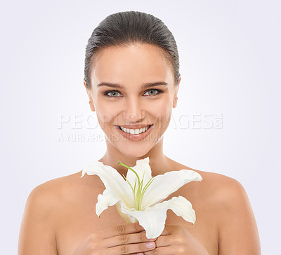 Buy stock photo Cosmetic, floral and portrait of woman in studio with glamour, glow and natural face routine. Beauty, confident and young female person with flower plant for facial cosmetology by white background.