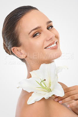 Buy stock photo Makeup, beauty and woman with flower in studio with natural, glow and cosmetic face routine. Portrait, confident and young female person with floral plant for facial cosmetology by white background.