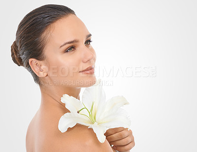 Buy stock photo Makeup, flower and beautiful woman in studio with glamour, glow and cosmetic face routine. Beauty, mockup and young female person with floral plant for facial cosmetology by white background.