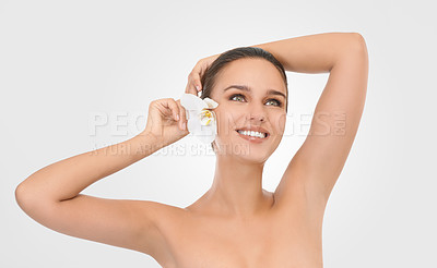 Buy stock photo Skincare, flower and woman with beauty, smile and wellness on a white studio background. Person, model and girl with natural cosmetics and shine with smooth and dermatology with glow and aesthetic