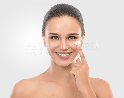 Buy stock photo Woman, beauty and cream in studio portrait, hydration and skincare glow on white background. Female person, routine and apply lotion for facial treatment, cosmetics and moisturizer for soft skin