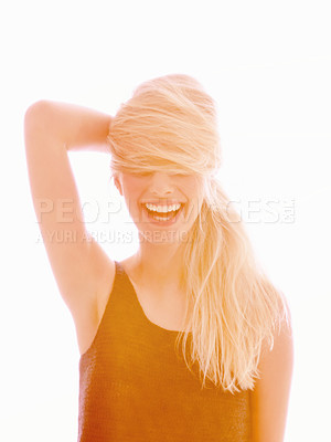 Buy stock photo A young woman laughing with her hair covering her eyes