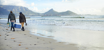 Buy stock photo Fishermen, equipment or walking on beach for fishing on cloudy morning or afternoon in Cape Town. Friends, men or male tourists with net, pole and cooler box by sea, shore or coast for mockup