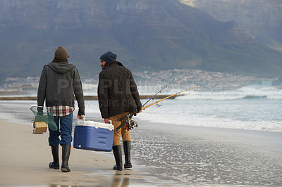 Buy stock photo Ocean, fishing and men walking together with cooler, tackle box and holiday conversation from back. Beach, fisherman and friends with rods, bait and tools at waves on winter morning vacation at sea.